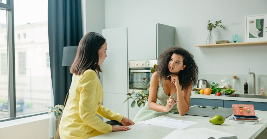 Two women engage in a conversation about nutrition in a stylish kitchen setting.